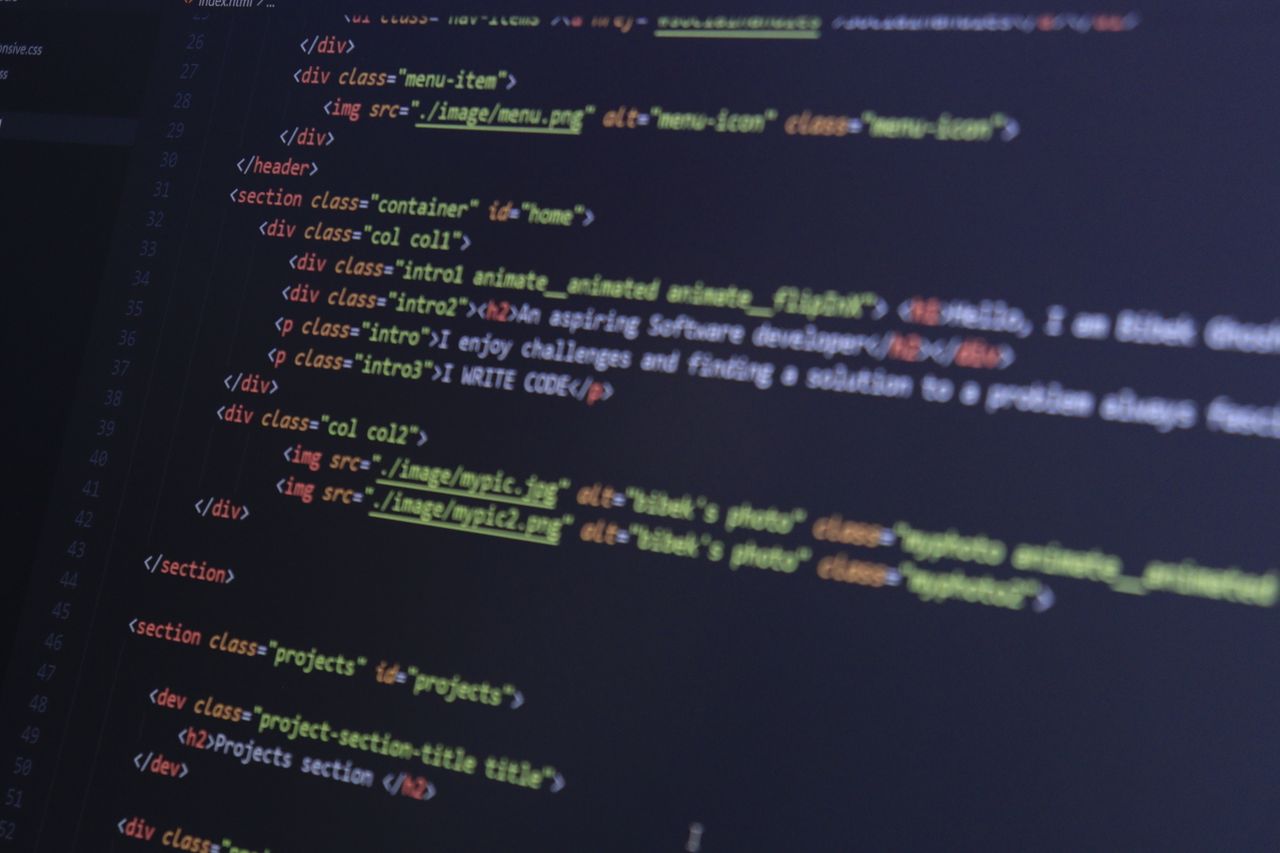 heros-img HTML and CSS code on a computer monitor, highlighting web development and programming.
